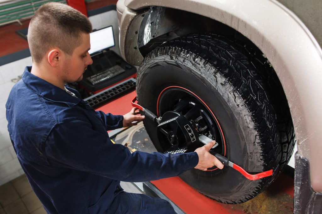 A service technician performing a tire alignment. 