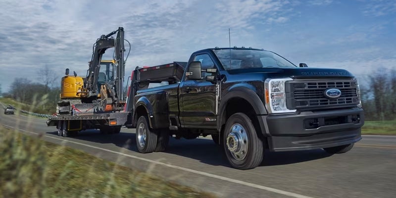 A Ford Super Duty towing a construction steamshovel.
