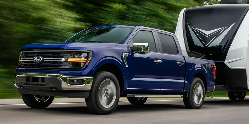 a blue Ford F150 tows a travel trailer in Illinois