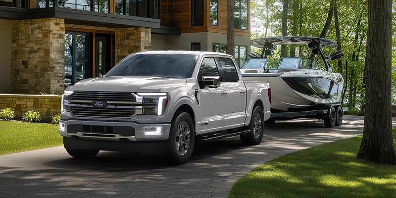 Front view of 2026 Ford F-150 truck towing a boat